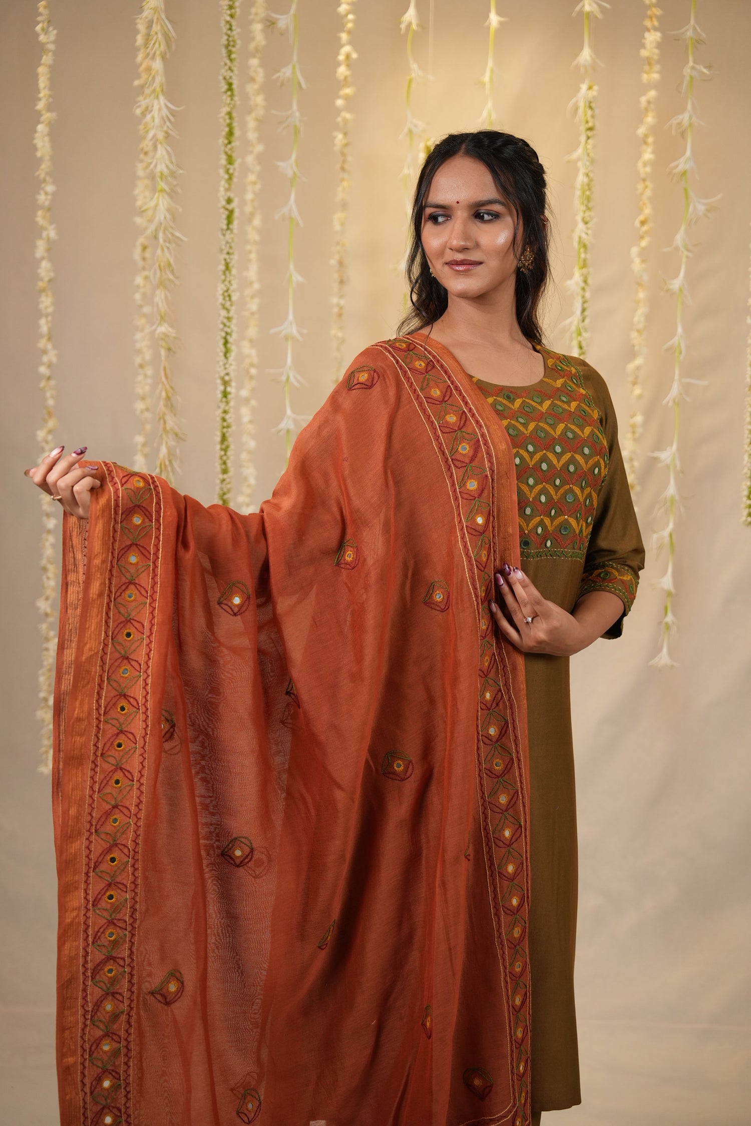 Woman wearing a traditional outfit with intricate designs for diwali festival 2025